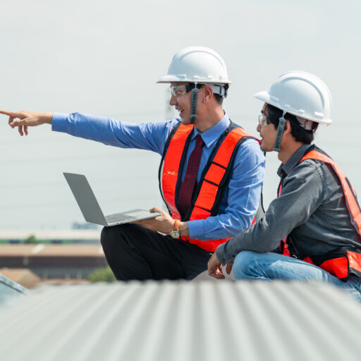 Engineers and technicians check drawings for installing solar cell panels on the roof. alternative energy energy from the sun